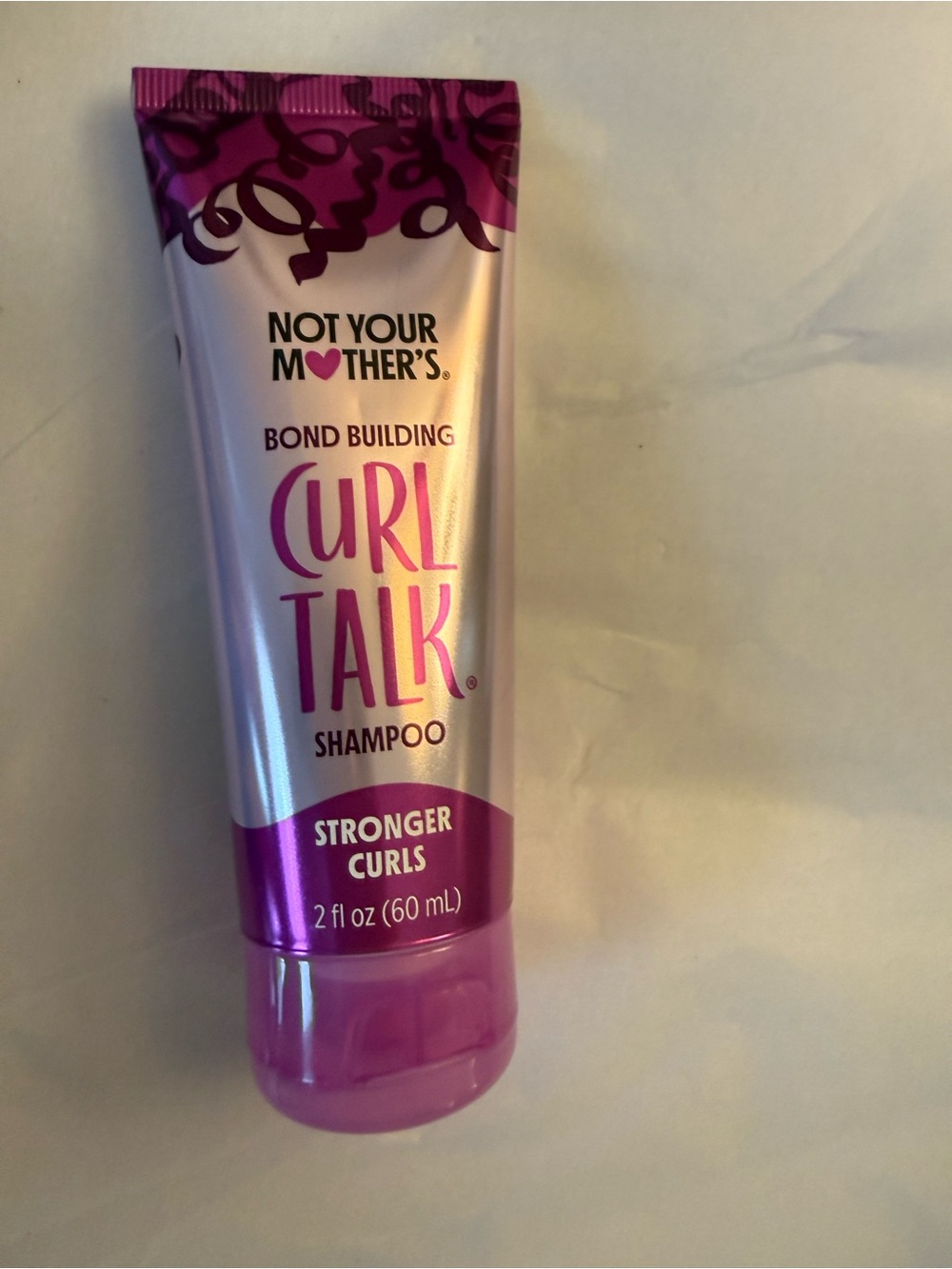 Not Your Mother's Curl Talk Bond Building Shampoo 2 fl oz travel-sized tube.